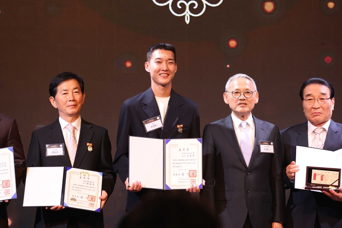 우상혁 선수가 10월 31일 서울 더 플라자 호텔에서 열린 ‘제61회 대한민국체육상’ 시상식에서 유인촌 문화체육관광부장관으로부터 경기상을 받고 있는 모습.