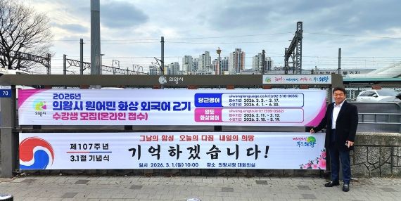 의왕역 앞 행정현수막게시대에 걸린 삼일절 기념현수막 앞에서 기념촬영하고 있는 한채훈 의왕시의회 의원
